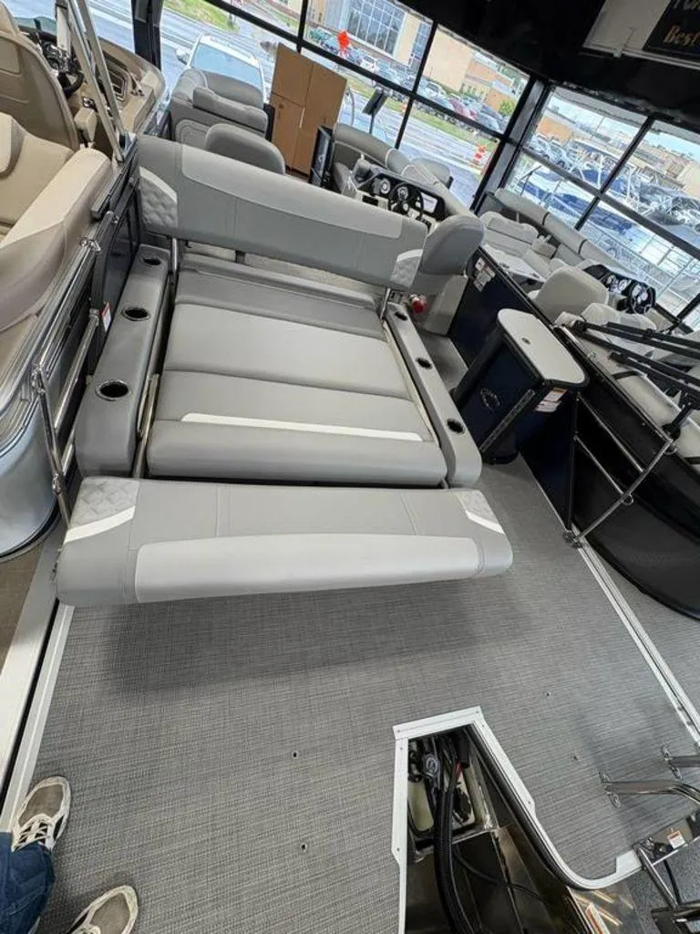 Slide: The Image of 2025 Crest Classic 220 SLSC Tritoon interior with gray seating and modern design. - 9