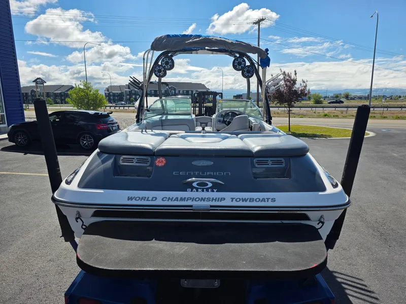 Slide: The Image of 2007 Centurion Boats ENZO23, rear view, parked outdoors under a partly cloudy sky. - 10