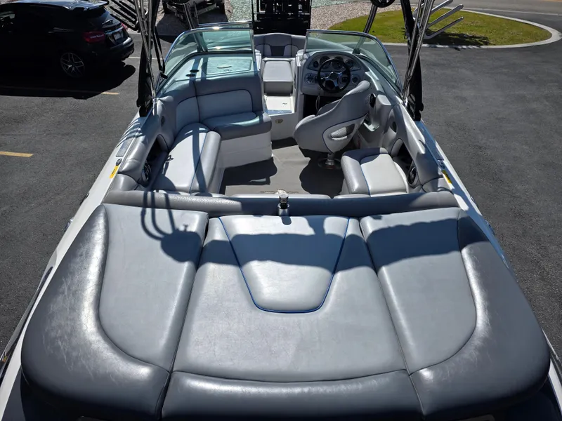 Slide: The Image of 2007 Centurion Boats ENZO23 interior with gray seating and steering wheel, parked on asphalt. - 11