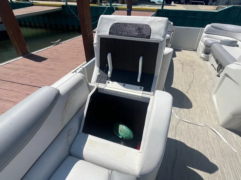 Slide: The Image of 2018 Tahoe Cascade 2585 CR boat with open storage compartment on deck. - 13