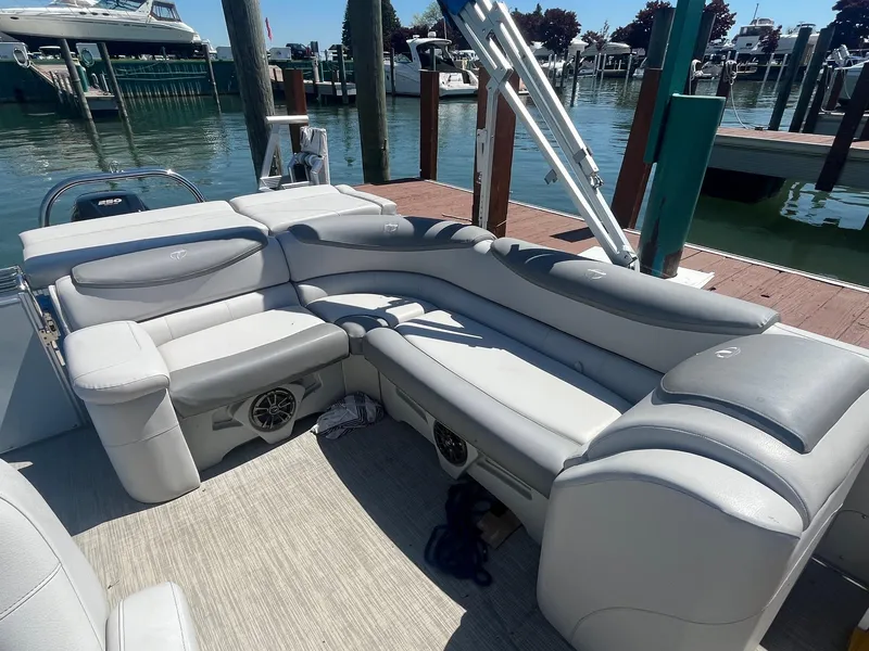 Slide: The Image of 2018 Tahoe Cascade 2585 CR pontoon boat with plush seating at a marina dock. - 4