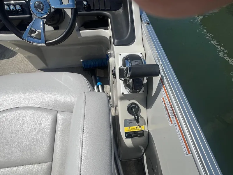 Slide: The Image of 2018 Tahoe Cascade 2585 CR boat cockpit with steering wheel and throttle controls. - 8