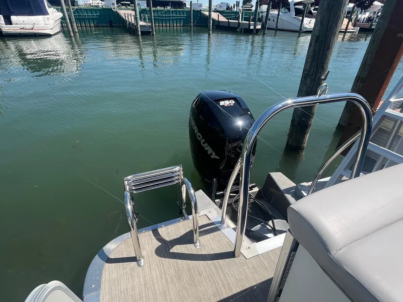 Slide: The Image of 2018 Tahoe Cascade 2585 CR boat with Mercury engine at dockside. - 9