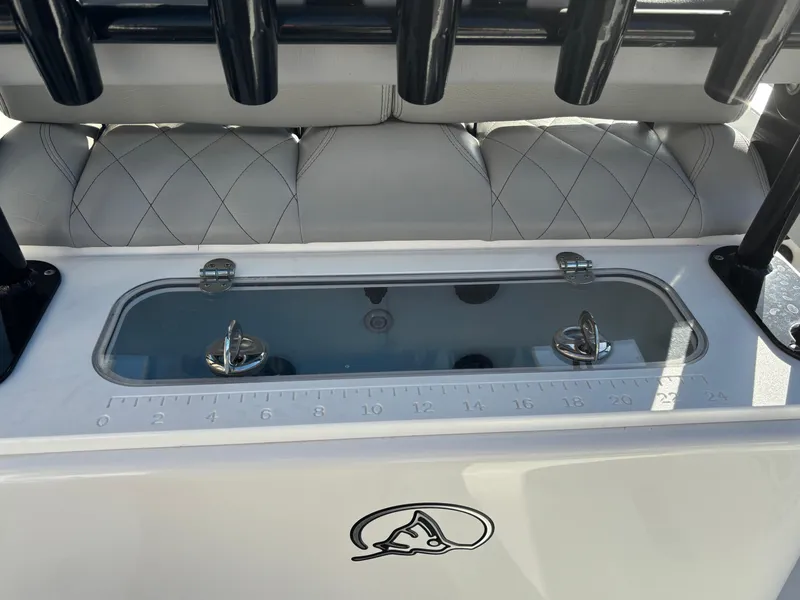 Slide: The Image of 2023 Blazer 2700 HYBRID BAY boat interior with storage compartment and rod holders. - 14