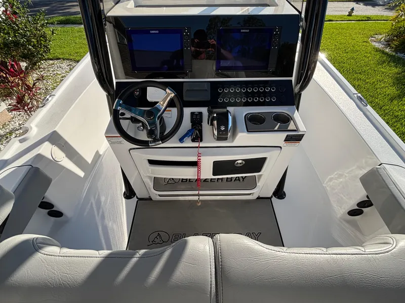Slide: The Image of 2023 Blazer 2700 HYBRID BAY boat cockpit with steering wheel and control panel. - 15
