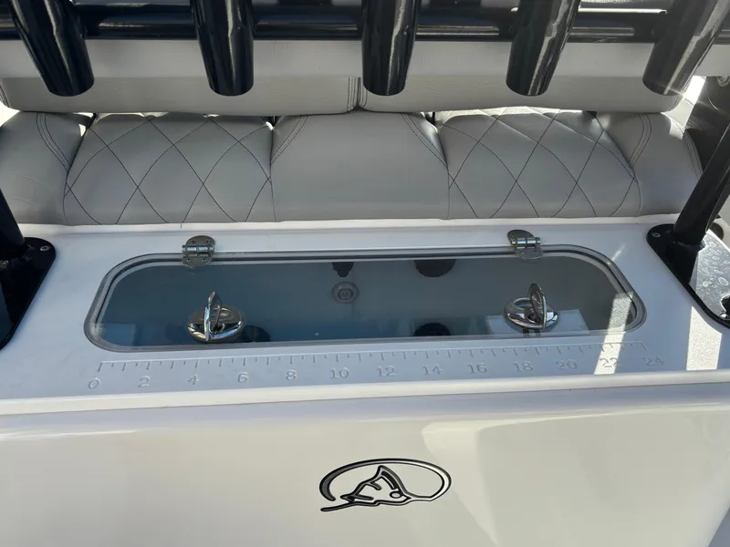 Slide: The Image of 2023 Blazer 2700 HYBRID BAY boat interior with storage compartment and measuring scale. - 21