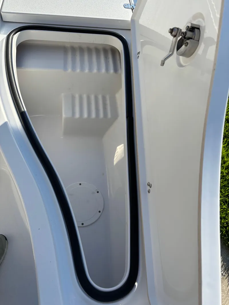 Slide: The Image of 2023 Blazer 2700 HYBRID BAY boat storage compartment with open hatch and secure latch. - 22