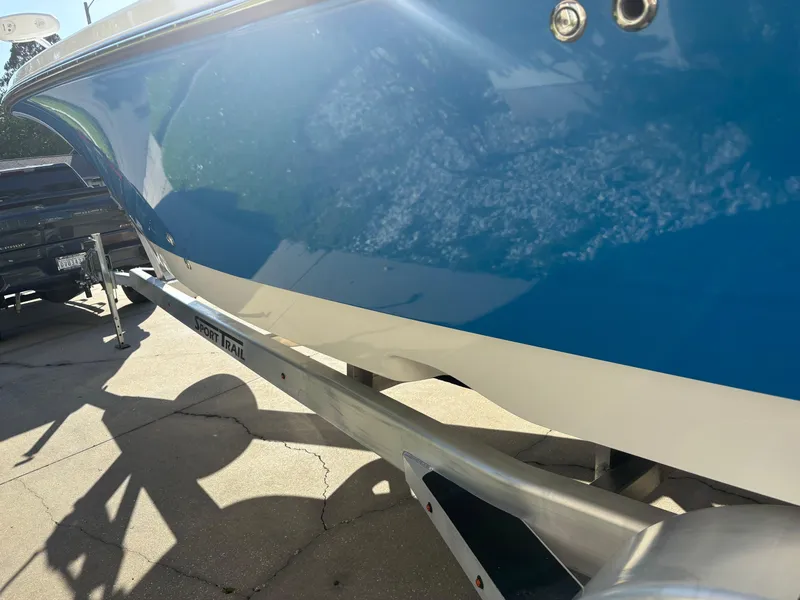 Slide: The Image of 2023 Blazer 2700 HYBRID BAY boat on trailer, blue and white hull. - 5