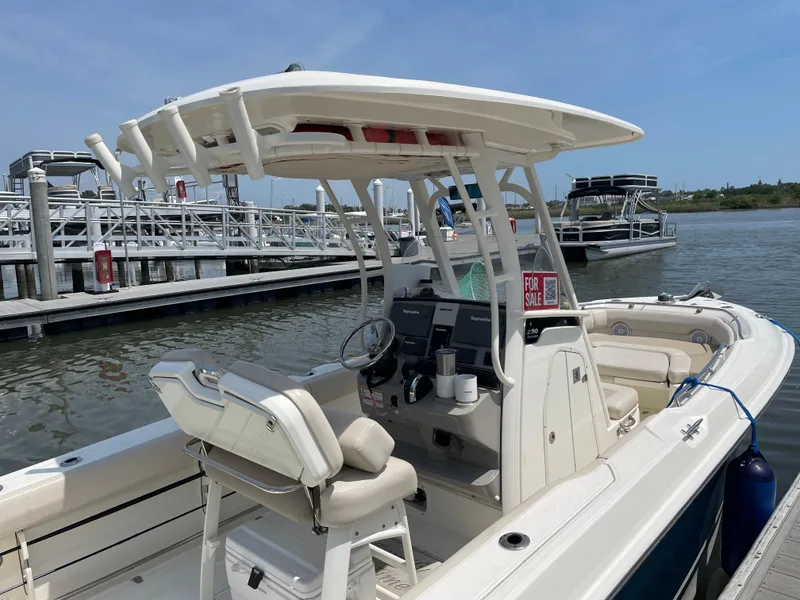 Slide: The Image of 2017 Boston Whaler 230 Outrage boat docked, featuring a center console and "For Sale" sign. - 14