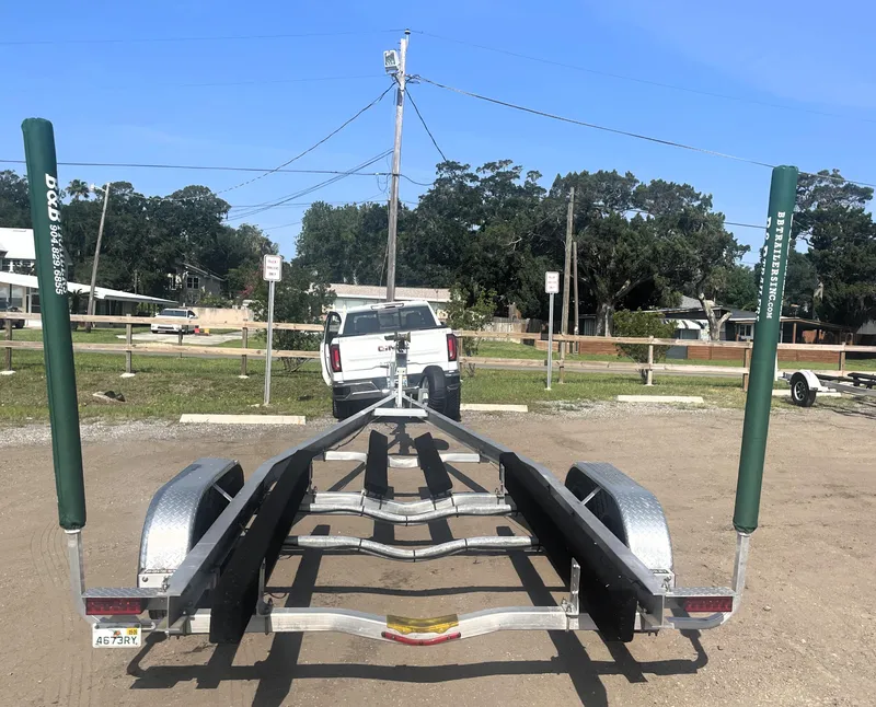 Slide: The Image of Trailer for 2017 Boston Whaler 230 Outrage, parked in a lot with a truck. - 17