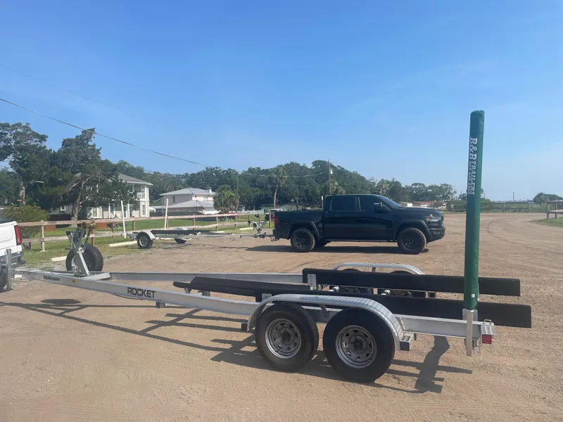 Slide: The Image of Trailer for 2017 Boston Whaler 230 Outrage, parked in a sunny lot. - 18