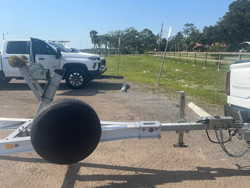 Slide: The Image of Trailer for 2017 Boston Whaler 230 Outrage in parking lot with trucks nearby. - 21