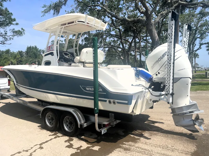 Slide: The Image of 2017 Boston Whaler 230 Outrage boat on trailer, parked outdoors. - 5