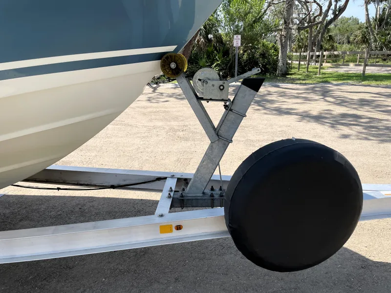 Slide: The Image of 2017 Boston Whaler 230 Outrage on trailer, close-up of bow and wheel assembly. - 6
