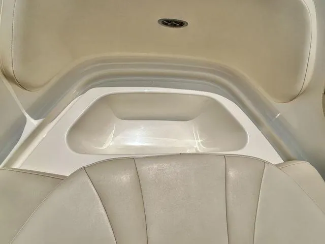 Slide: The Image of 2006 Chaparral 204 SSi boat interior with beige seating and storage compartment. - 13