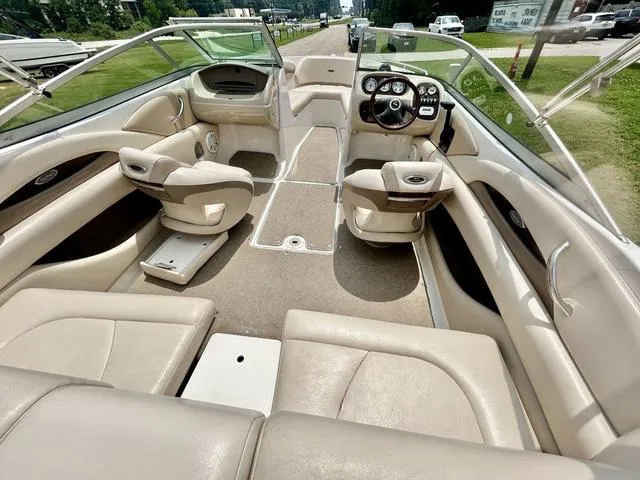 Slide: The Image of 2006 Chaparral 204 SSi boat interior with beige seating and steering console. - 18