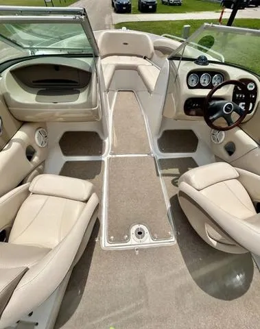 Slide: The Image of 2006 Chaparral 204 SSi boat interior with beige seating and modern dashboard. - 19