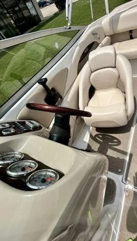 Slide: The Image of 2006 Chaparral 204 SSi boat interior with beige seating and dashboard gauges. - 20