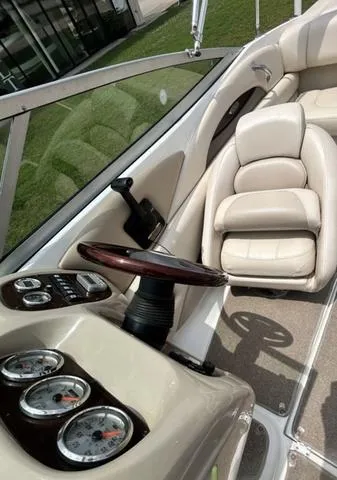 Slide: The Image of 2006 Chaparral 204 SSi boat interior with beige seating and dashboard gauges. - 21