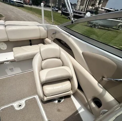 Slide: The Image of 2006 Chaparral 204 SSi boat interior with beige seating and carpeted flooring. - 22