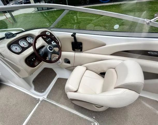 Slide: The Image of 2006 Chaparral 204 SSi boat interior with steering wheel and beige seating. - 24