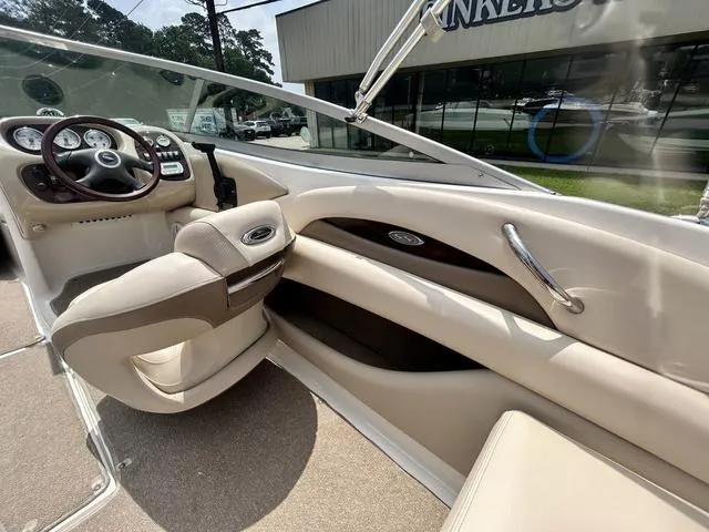 Slide: The Image of Interior of 2006 Chaparral 204 SSi boat, featuring beige seating and dashboard controls. - 29