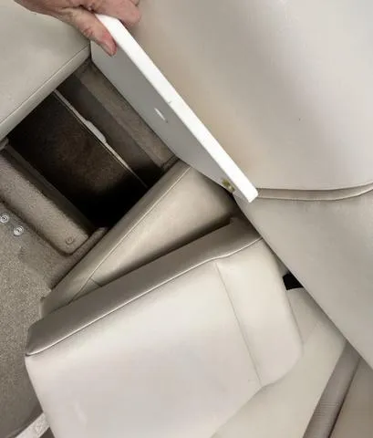 Slide: The Image of 2006 Chaparral 204 SSi boat interior with storage compartment and beige seating. - 33