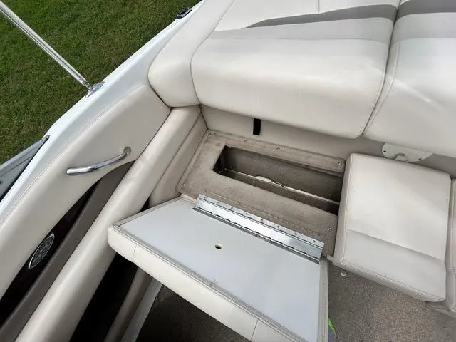 Slide: The Image of 2006 Chaparral 204 SSi boat interior with open storage compartment and cushioned seating. - 35