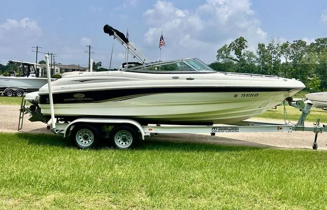Slide: The Image of 2006 Chaparral 204 SSi boat on trailer, parked on grass under cloudy sky. - 4