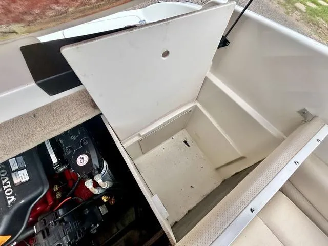 Slide: The Image of Open storage compartment in 2006 Chaparral 204 SSi boat, showing engine and interior details. - 43