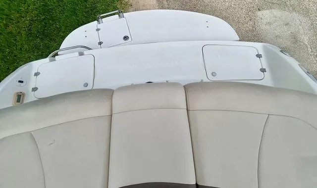 Slide: The Image of 2006 Chaparral 204 SSi boat interior with beige seating and storage compartments. - 45