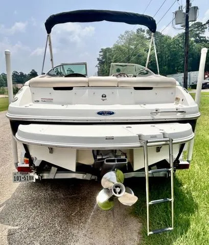 Slide: The Image of 2006 Chaparral 204 SSi boat, rear view with ladder and propeller, parked on roadside. - 7