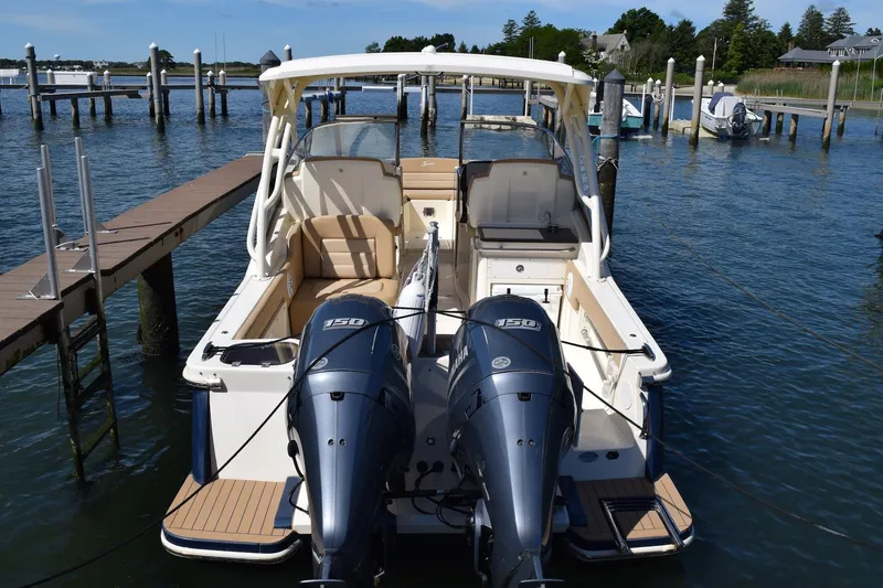 Slide: The Image of 2020 Scout 255 Dorado boat docked with twin engines, viewed from the rear. - 1