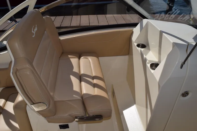 Slide: The Image of 2020 Scout 255 Dorado boat interior with beige seating and cup holders. - 10