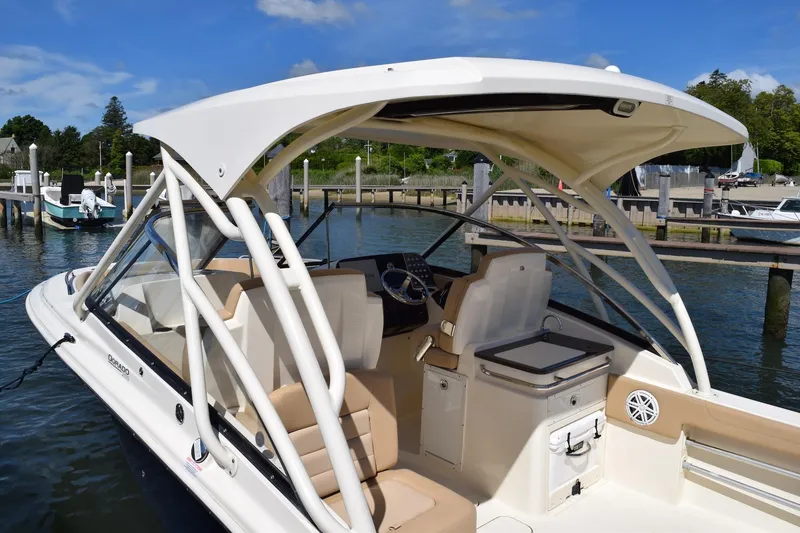 Slide: The Image of 2020 Scout 255 Dorado boat docked, featuring spacious seating and sleek design. - 14