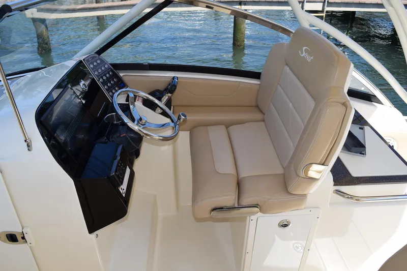 Slide: The Image of 2020 Scout 255 Dorado boat interior with beige seating and steering console. - 15