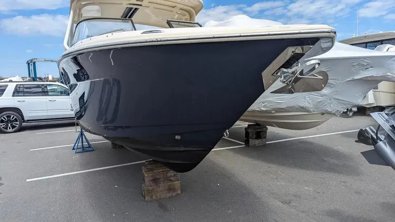 Slide: The Image of 2020 Scout 255 Dorado boat on blocks in a parking lot. - 2