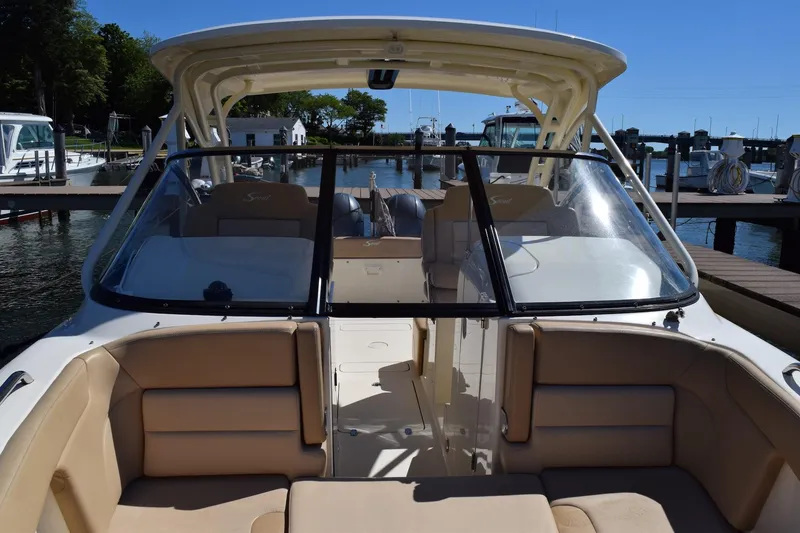 Slide: The Image of 2020 Scout 255 Dorado boat interior with beige seating, docked at marina. - 3