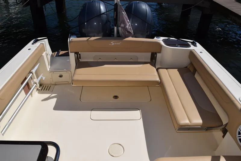 Slide: The Image of 2020 Scout 255 Dorado boat interior with beige seating and twin engines. - 9