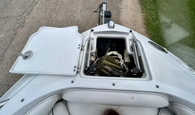 Slide: The Image of 2005 Crownline 216 LS boat with open storage compartment on deck. - 14