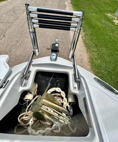 Slide: The Image of 2005 Crownline 216 LS boat anchor storage with ropes and ladder. - 15