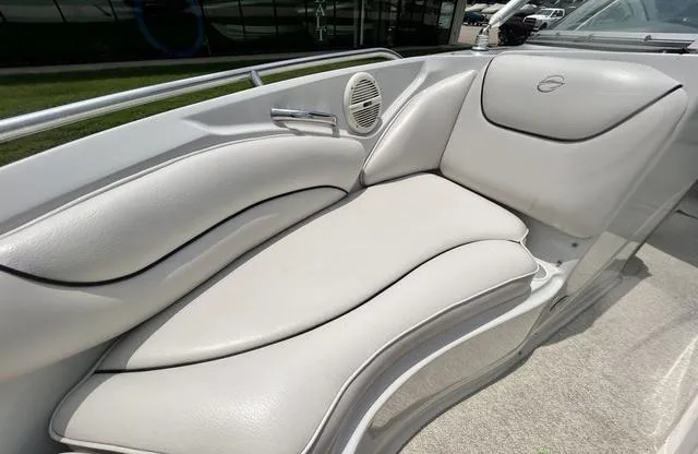 Slide: The Image of 2005 Crownline 216 LS boat interior with white cushioned seating and speaker. - 18