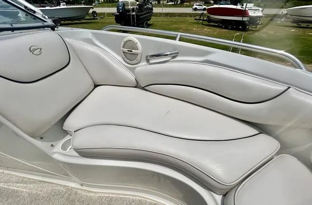 Slide: The Image of 2005 Crownline 216 LS boat interior with white cushioned seating and speaker. - 20