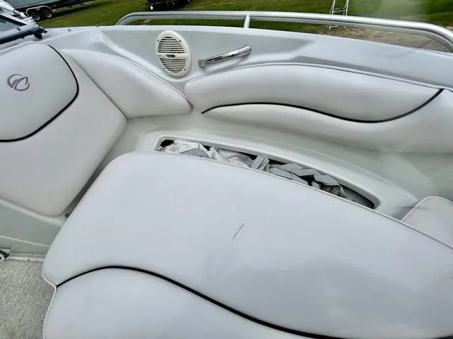 Slide: The Image of 2005 Crownline 216 LS boat interior with white cushioned seating and speaker. - 21