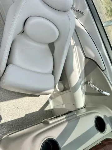 Slide: The Image of 2005 Crownline 216 LS boat interior with white seating and cup holders. - 24