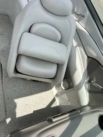 Slide: The Image of 2005 Crownline 216 LS boat interior with white seating and carpeted flooring. - 25
