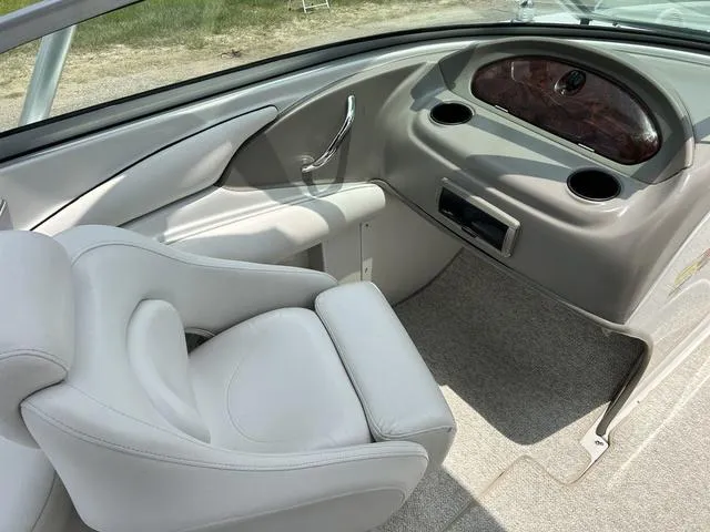 Slide: The Image of 2005 Crownline 216 LS boat interior with white seating and dashboard. - 28