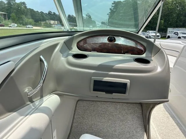 Slide: The Image of 2005 Crownline 216 LS boat interior dashboard with cup holders and steering wheel. - 29