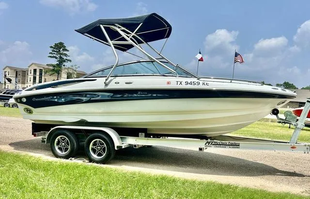 Slide: The Image of 2005 Crownline 216 LS boat on trailer with canopy, parked outdoors. - 3