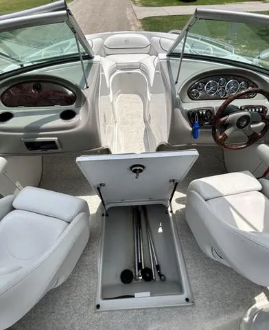 Slide: The Image of 2005 Crownline 216 LS boat interior with open storage compartment and dashboard view. - 31